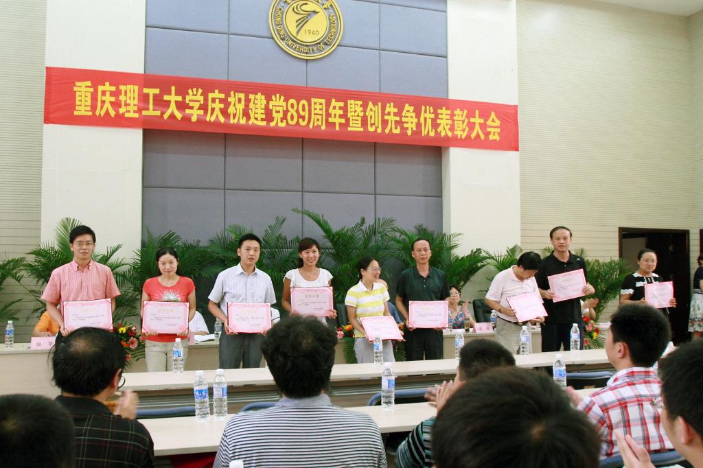学校领导为受到表彰的王毅、郭敏娜等54名优秀共产党员个人代表颁发了证书